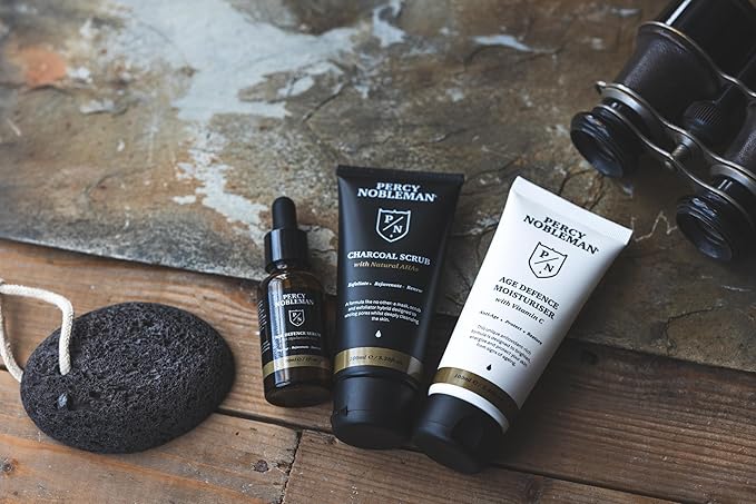 Percy Nobleman Age Defence Kit, a men's skincare set containing Charcoal Face Scrub (with Natural AHAs), ultra-hydrating Facial Serum (with Hyaluronic Acid), and Moisturiser (with Vitamin C)